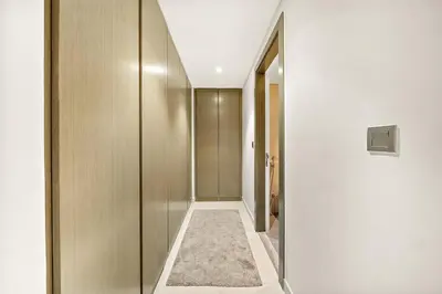 a hallway with a walk in closet and a hallway at Luxe 1BR with Balcony & Canal View in Dubai