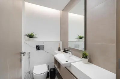 a bathroom with two sinks and a toilet and a mirror at Luxury 2BR LIV Marina Dubai World-Class Amenities in Dubai