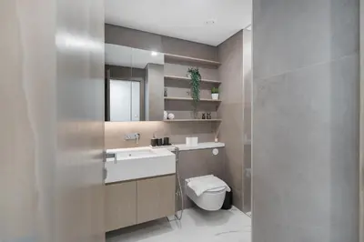 a bathroom with a sink and a toilet and a mirror at Luxury 2BR LIV Marina Dubai World-Class Amenities in Dubai