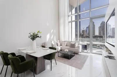 a white living room with a table and chairs at Luxury 2BR LIV Marina Dubai World-Class Amenities in Dubai