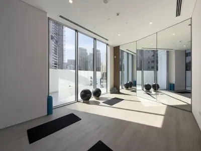 a room with a lot of windows and yoga mats at Luxury 2BR LIV Marina Dubai World-Class Amenities in Dubai