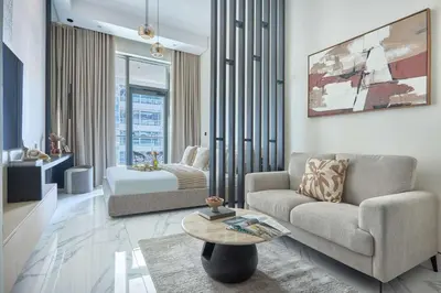 a living room with a couch and a table at Frank Porter - J One Tower in Dubai