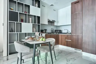 a kitchen with a small table and two chairs at Frank Porter - J One Tower in Dubai