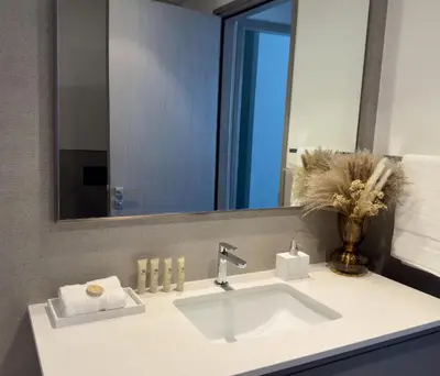 a bathroom with a sink and a mirror at GRANDE SIGNATURE RESIDENCES direct Burj Khalifa view and Private Fountain Show at high floor with DXB AIRPORT VIP Shuttle option in Dubai