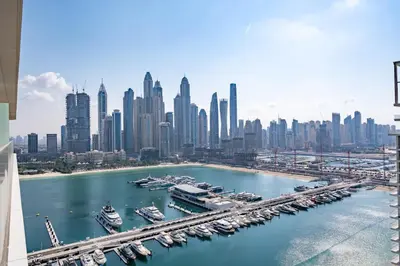 an aerial view of a city with boats in a harbor at Luxury Sea View 1BR l Palace Beach Residence in Dubai