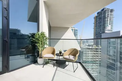 a balcony with chairs and a table on a building at Exclusive 1BR W Private Pool Binghatti Royale in Dubai