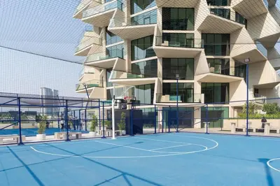 a rendering of a tennis court in front of a building at Exclusive 1BR W Private Pool Binghatti Royale in Dubai