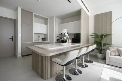a kitchen with a counter and stools in a room at Exclusive 1BR W Private Pool Binghatti Royale in Dubai