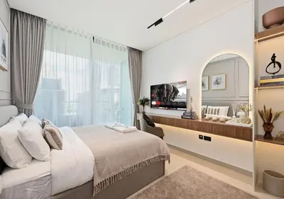 a bedroom with a large bed and a large window at Stylish JVC Studio Hotel-Style Comfort in Dubai