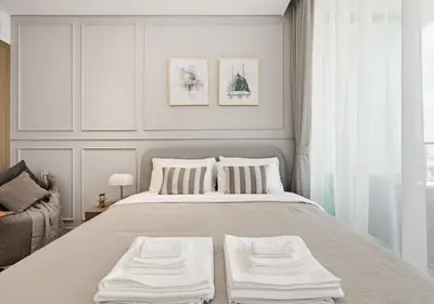a bedroom with a large bed with two white pillows at Stylish JVC Studio Hotel-Style Comfort in Dubai