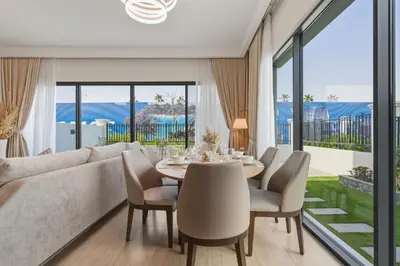 a living room with a couch and a table and chairs at Five-Bedroom plus maid's room villa with Multiple En-Suites Sunset Roof Terraces & Exceptional Space in Dubai