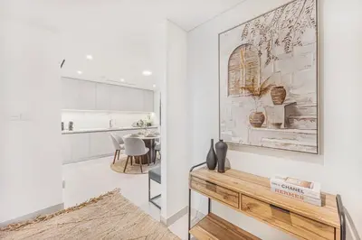 a living room with a table and a kitchen at Beachfront stay at Beach Mansion with Private Beach in Dubai