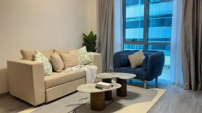 a living room with a couch and a chair at 1BDR Centrally Located Near Metro in Dubai