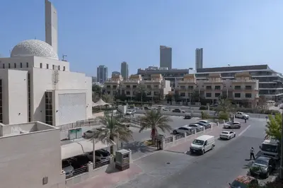 a city with cars parked in a parking lot at StayShort - Modern JVC 1 bed Sleeps 4 with Swimming Pool in Dubai