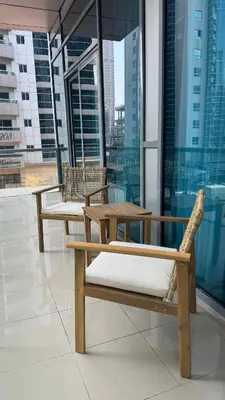 two chairs and a table on top of a building at 1BDR Centrally Located Fully Equipped Kitchen in Dubai