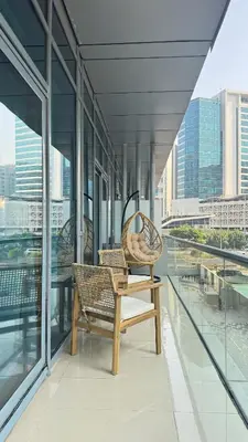 two chairs on a balcony with a view of the city at 1BDR Centrally Located Fully Equipped Kitchen in Dubai