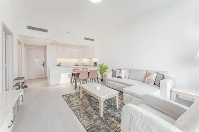 a living room with a couch and a table at HAVN - 1 bed in Luma Parks, JVC in Dubai