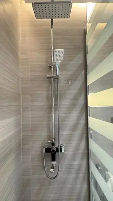 a shower with a shower head in a bathroom at 1 Bedroom Centrally located near the Metro in Dubai
