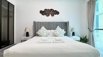 a bedroom with a large white bed with two pillows at 1 Bedroom Centrally located near the Metro in Dubai