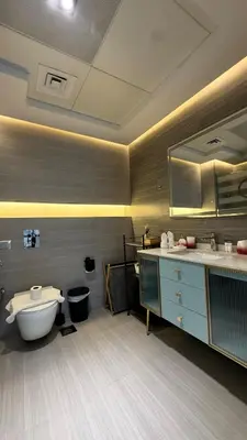 a bathroom with a tub and a toilet and a sink at 1 Bedroom Centrally located near the Metro in Dubai