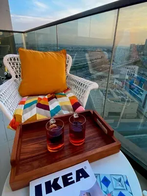 a tray with two drinks on a table on a balcony at Stylish 2BR in Business Bay with all essentials in Dubai