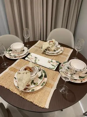 a table with plates and napkins on top at Stylish 2BR in Business Bay with all essentials in Dubai