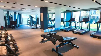 a gym with several treadmills and exercise bikes at Stylish 2BR in Business Bay with all essentials in Dubai