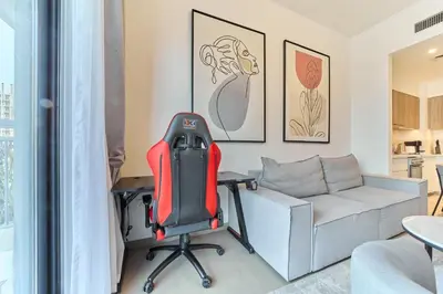 a office with a red chair and a desk at Bright 1BR in Executive Residences 2, Dubai Hills in Dubai