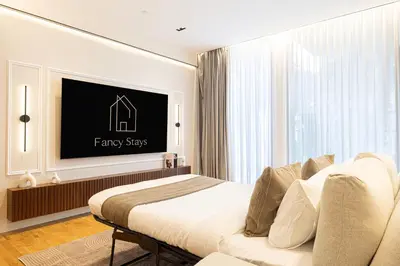 a bedroom with a bed and a flat screen tv at Island Living in Bluewaters, Close to JBR Beach in Dubai