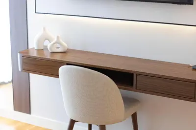 a desk with a chair in front of a television at Island Living in Bluewaters, Close to JBR Beach in Dubai
