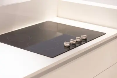 a stove top oven in a white kitchen at Island Living in Bluewaters, Close to JBR Beach in Dubai