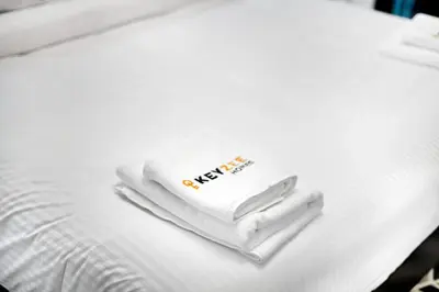 a pile of towels sitting on top of a bed at Modern 2BDR Stay-Near Metro-Al Furjan in Dubai