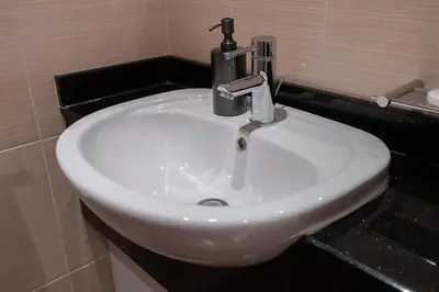 a white bathroom sink with a faucet on it at Modern 1BHK Jewels Tower, Dubai Marina by Czechin in Dubai