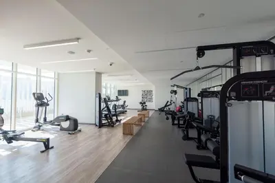 a gym with treadmills and machines in a room at VayK - Elegant 2BR at Emaar Beachfront with Beach Access in Dubai