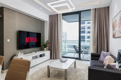 a living room with a tv and a couch at VayK - Extra-Large 2BR in Dubai Hills Close to Mall & Park in Dubai