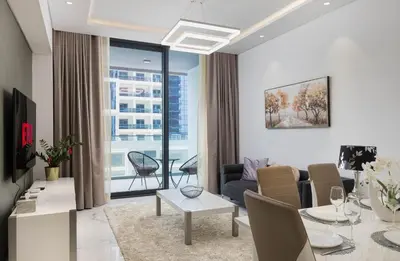 a living room with a couch and a table at VayK - Extra-Large 2BR in Dubai Hills Close to Mall & Park in Dubai
