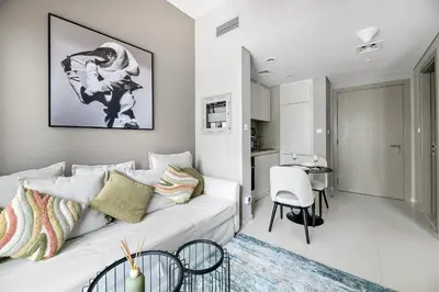 a white living room with a white couch and a table at VayK - Newly Launched 1BR in Business Bay in Dubai