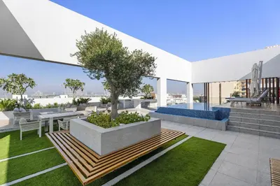 a patio with a tree on top of a building at VayK - Contemporary 1BR in a New JVC Community in Dubai