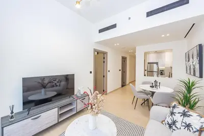 a living room with a large flat screen tv at VayK - Chic 1BR Urban Getaway in Dubai