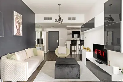 a living room with a white couch and a table at VayK - Modern 1BR Near Metro in Dubai Marina in Dubai