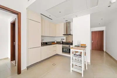 a kitchen with white cabinets and a ladder in it at VayK - Lovely 1BR in Central Dubai Marina in Dubai