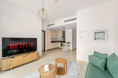 a living room with a couch and a tv at VayK - Lovely 1BR in Central Dubai Marina in Dubai