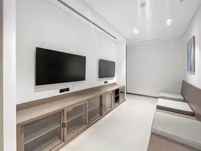 a living room with a flat screen tv on a wall at Luxury Apartments in Downtown Near Dubai Mall and Burj Khalifa View in Dubai
