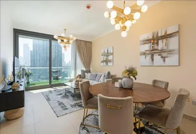 a living room with a table and a couch at Luxury Apartments in Downtown Near Dubai Mall and Burj Khalifa View in Dubai