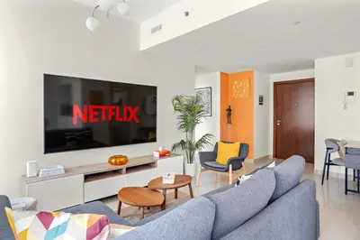 a living room with a couch and a tv at VayK - Inviting 1BR in Dubai Marina with Stunning Views in Dubai