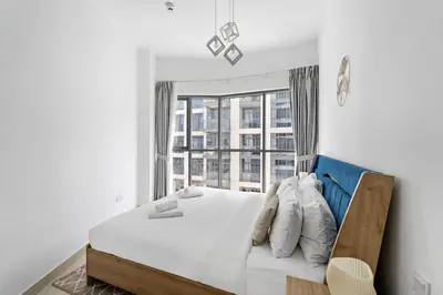 a bedroom with a bed with a large window at VayK - Generous 2BR Offering Burj Khalifa Views in Dubai