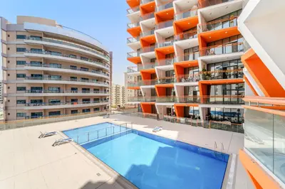 an image of an apartment building with a swimming pool at VayK - Chic Studio in Silicon Oasis with Pool View in Dubai