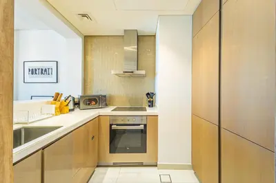 a kitchen with a sink and a stove at Superhost - 1BR , Pool & Gym , DAMAC Towers Paramount in Dubai