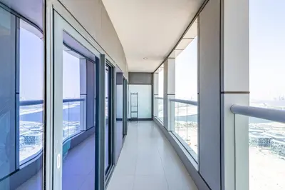 an empty corridor in a building with windows at Superhost - 1BR , Pool & Gym , DAMAC Towers Paramount in Dubai