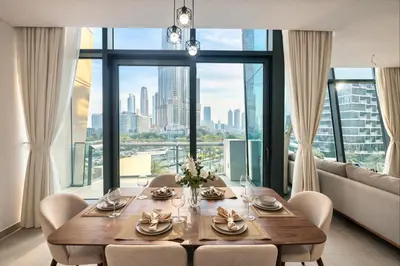 a dining room with a table and a large window at Signature Luxury Apartments Downtown Dubai in Dubai